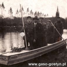 1781.Staw w Borku przy parku, grupa mezczyzn na lodzi Erika (1 pazdziernika 1939 r.), w oddali kosciol ewangelicki